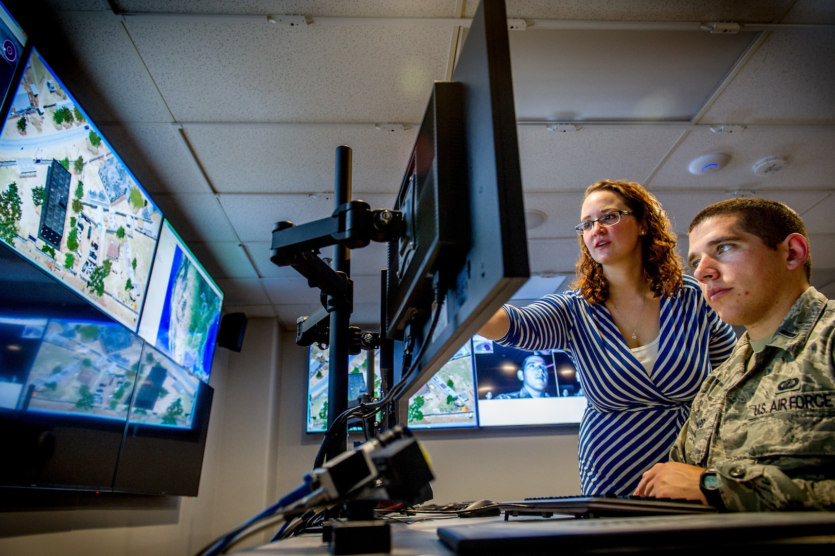 Associate research engineer Cassandra Stanfill, with Intelligence, Surveillance Augmentation, and Reconnaissance Branch, uses eye-tracking technology, among other methods, on test subject, Lieutenant Michael Emard, at Air Force Research Laboratory, Wright Patterson Air Force Base, Dayton, Ohio, July 21, 2016 (U.S. Air Force/J.M. Eddins, Jr.)