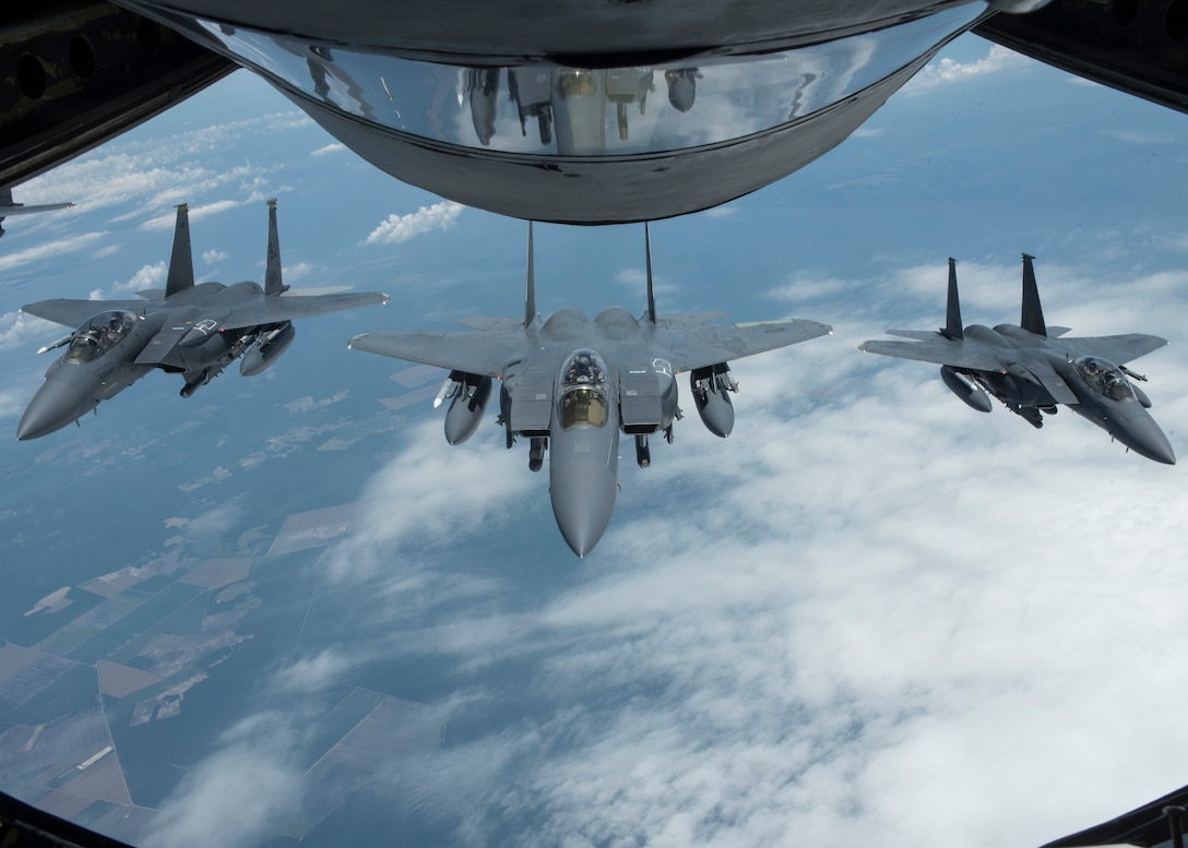 F-15E Strike Eagles with 4th Fighter Wing at Seymour Johnson Air Force Base, North Carolina, form behind KC-135 Stratotanker after refueling with 121st Air Refueling Wing, Ohio Air National Guard, June 15, 2018 (U.S. Air National Guard/Tiffany A. Emery)