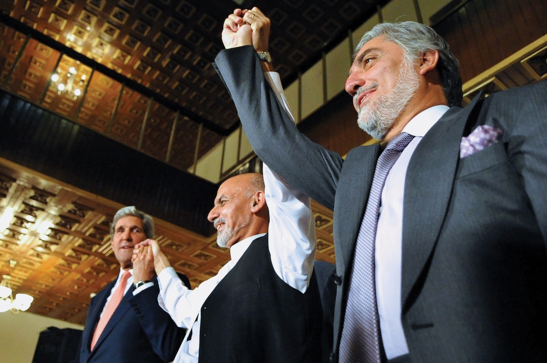 Former Secretary of State John Kerry raises hands with Afghan
presidential candidates Ashraf Ghani, left, and Abdullah Abdullah, right, at United Nations Mission Headquarters in Kabul, on July 12, 2014, after announcing deal to settle election dispute (U.S. Department of State)