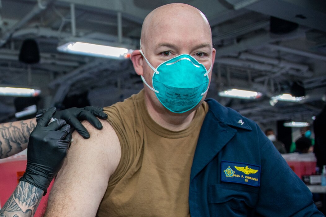 Capt. Paul Campagna, commanding officer of the Nimitz-class aircraft carrier USS Dwight D. Eisenhower (CVN 69), receives the COVID-19 vaccine.