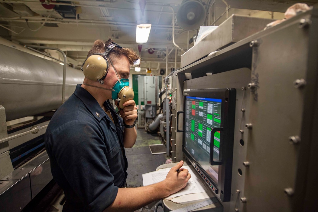 Aviation Boatswain's Mate (Equipment) 2nd Class Nicholas Harvey, from Eagle, Idaho, relays aircraft recovery data aboard the Nimitz-class aircraft carrier USS Dwight D. Eisenhower (CVN 69).