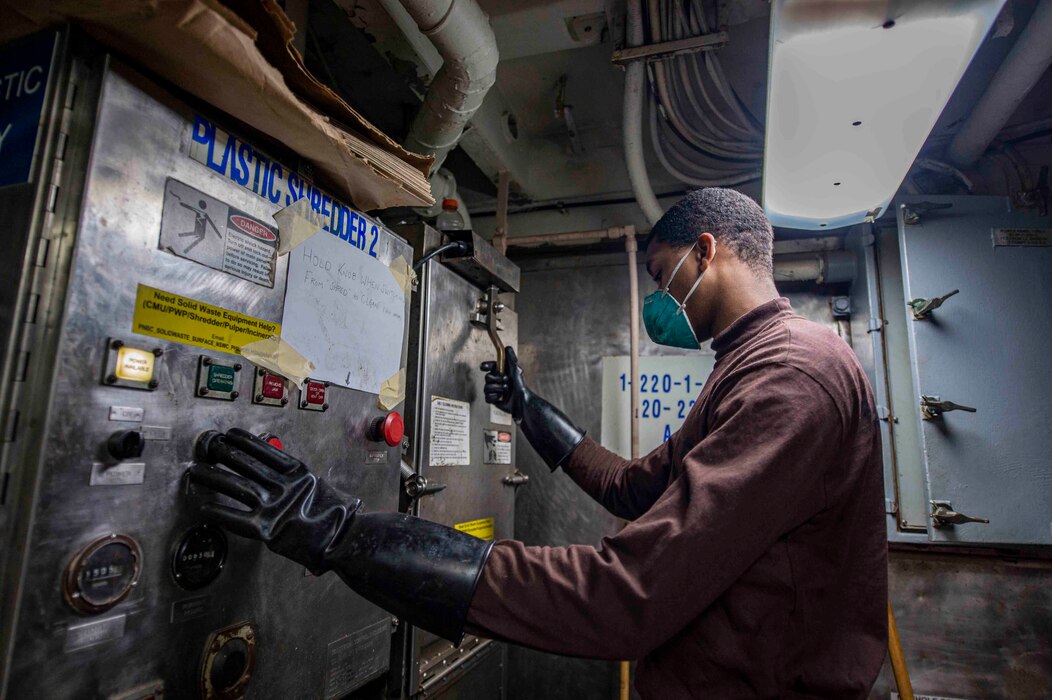 Airman Teyoan Hill, from Macon, Ga., processes waste aboard the Nimitz-class aircraft carrier USS Dwight D. Eisenhower (CVN 69).