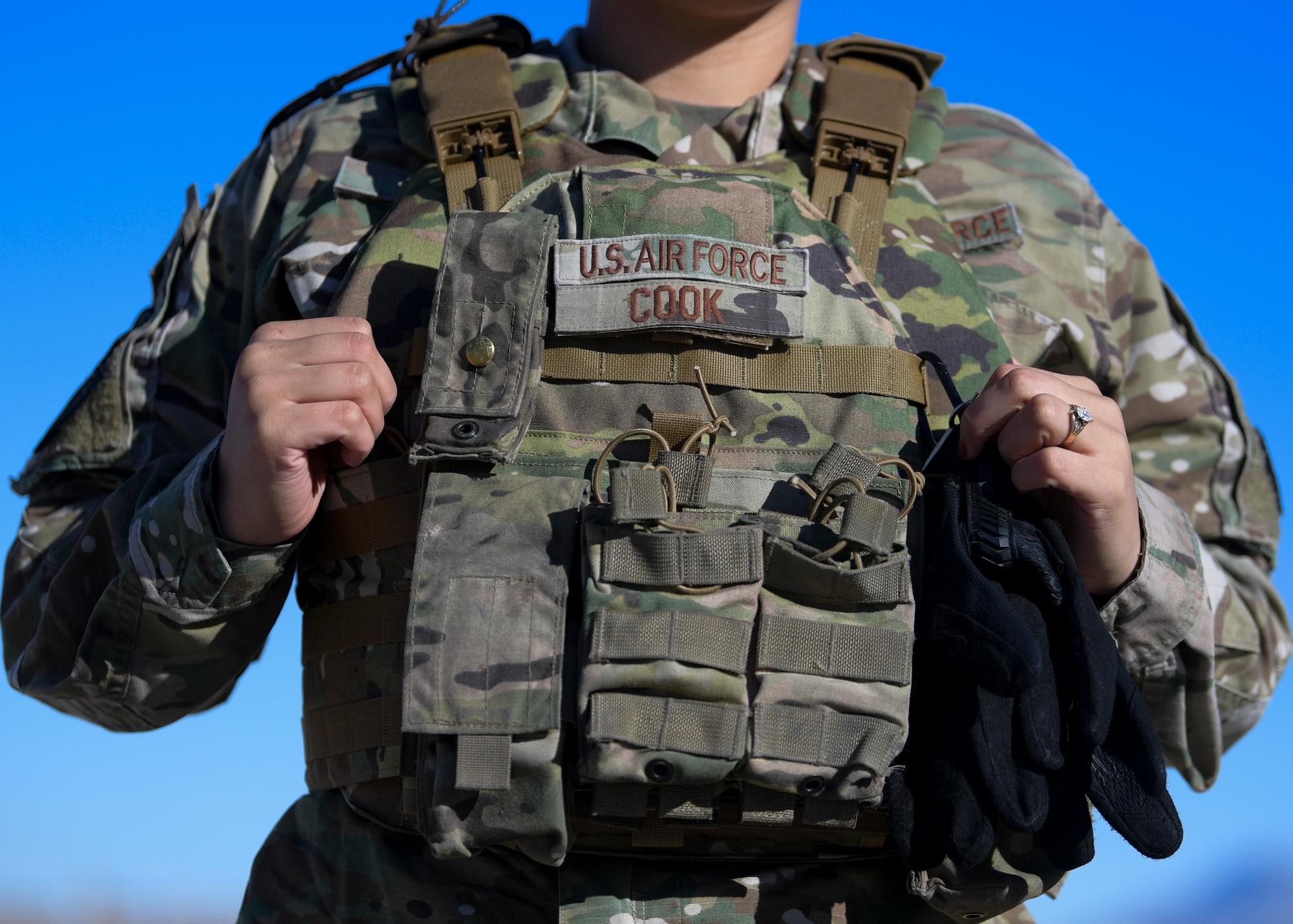 Senior Airman Kiah C. Cook, 377th Security Forces Group defender, donns her body armor at Kirtland Air Force Base, N.M., Feb. 4, 2021. Airmen from the 377th SFG were among the first Air Force defenders to receive the new issue of female body armor starting January 2021.