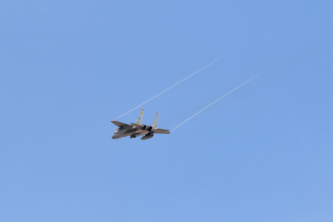 A fighter flies overhead