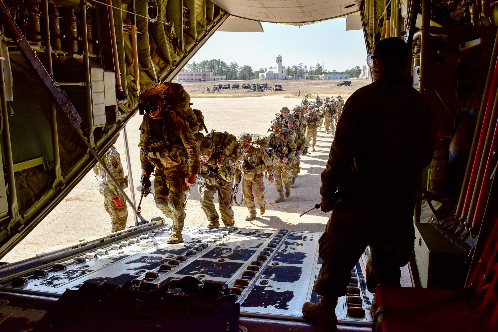 Soldiers board a plane