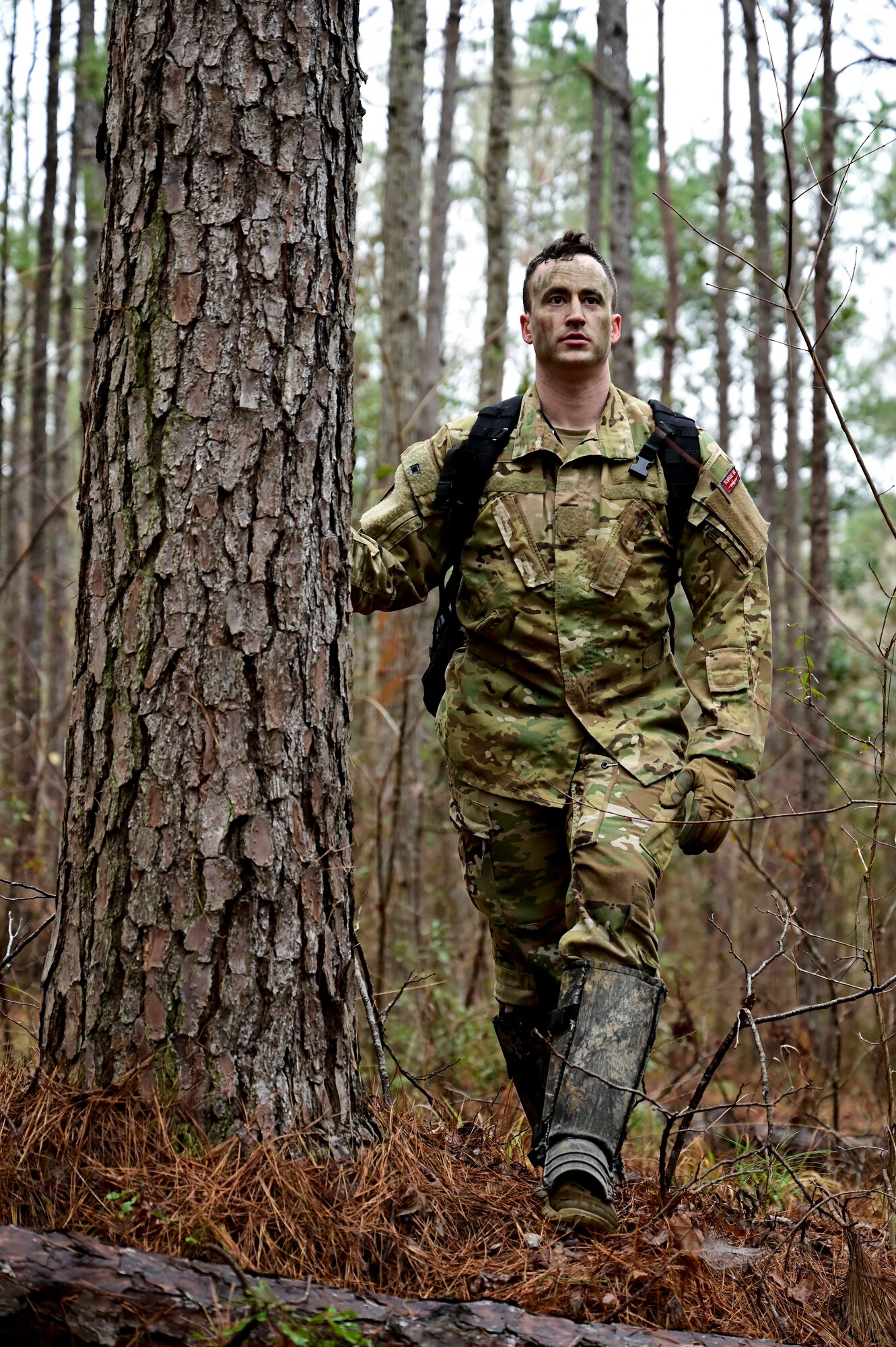 A man stand's by a tree