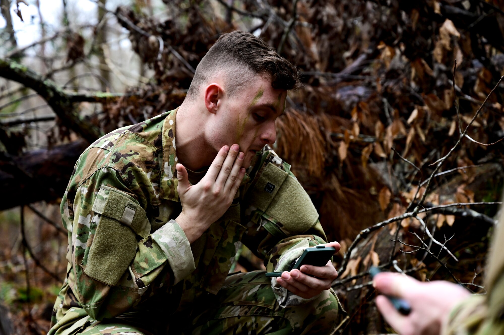 A man applies face paint