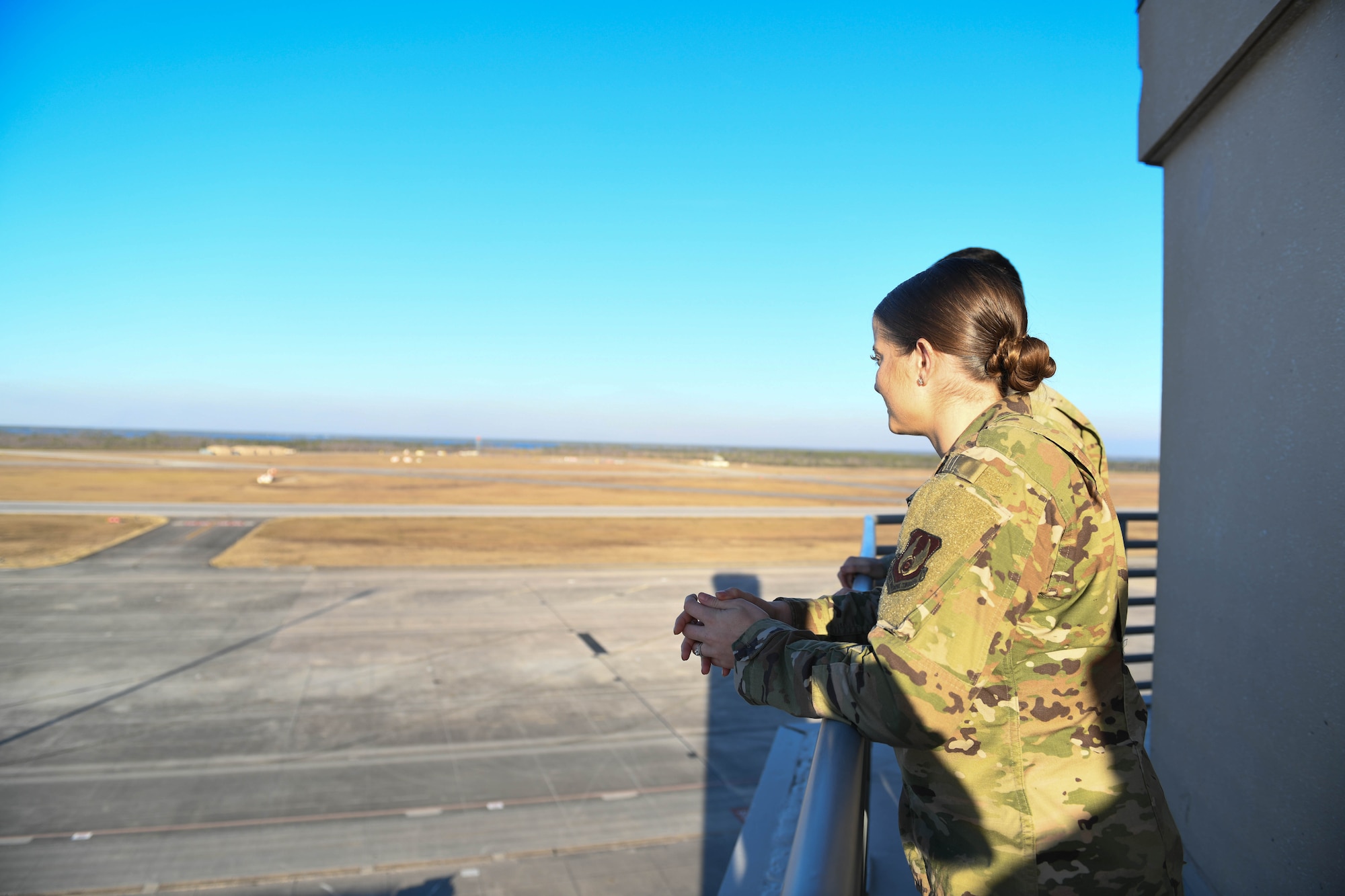 2nd Lt. Colleen Kuykendall looks at the flight line from the air traffic control tower.
