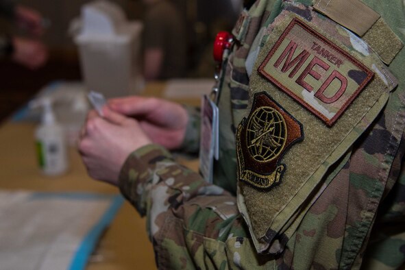 Airman 1st Class Rhiannon Ero, 22nd Operational Medical Readiness Squadron medical technician, prepares her station for the next patient to receive the COVID-19 vaccine Feb. 9, 2021, at McConnell Air Force Base, Kansas. The COVID-19 vaccine is currently being distributed to members across Team McConnell in alignment with the Department of Defense’s priorities to service members, DOD civilians and their families. (U.S. Air Force photo by Senior Airman Alexi Bosarge)