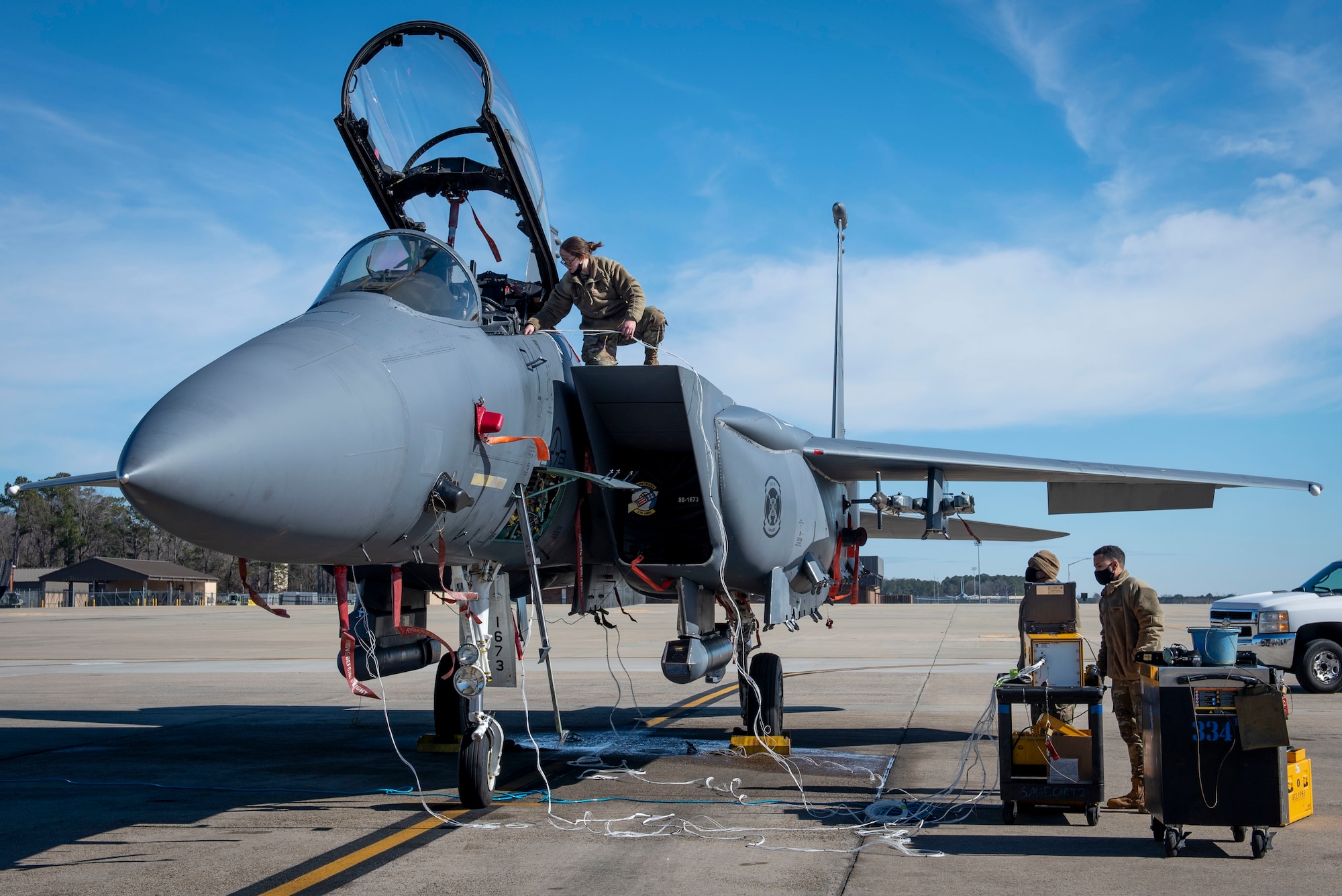 Senior Airman Kierra Hamil (left), 4th Component Maintenance Squadron electrical and environmental technician, connects a test harness to an F-15E Strike Eagle while Airman 1st Class Quentin Thompson (middle), 4th CMS electrical and environmental technician, and Senior Airman Thiago Santos (right), 4th Fighter Readiness Squadron electronics technician, set up an Eclypse tester program at Seymour Johnson Air Force Base, North Carolina, Feb. 3, 2021.
