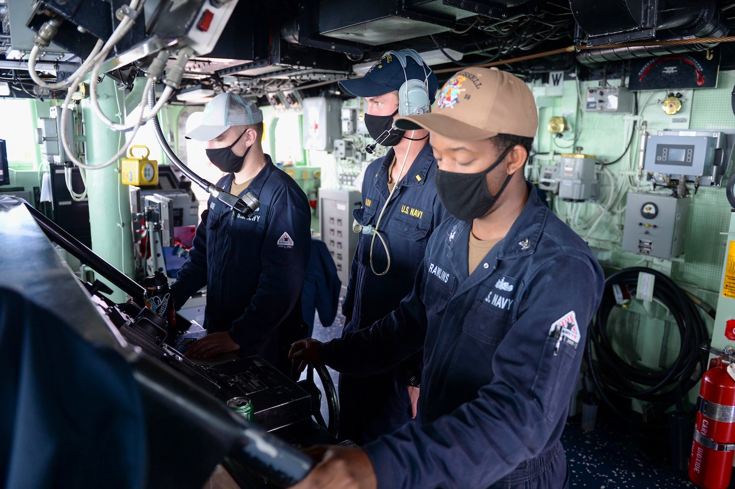 SOUTH CHINA SEA (Feb. 17, 2021) U.S. Sailors stand watch at the helm on the bridge as the guided-missile destroyer USS Russell (DDG 59) conducts routine underway operations. Russell is forward-deployed to the U.S. 7th Fleet area of operations in support of a free and open Indo-Pacific. (U.S. Navy photo by Mass Communication Specialist 3rd Class Wade Costin)