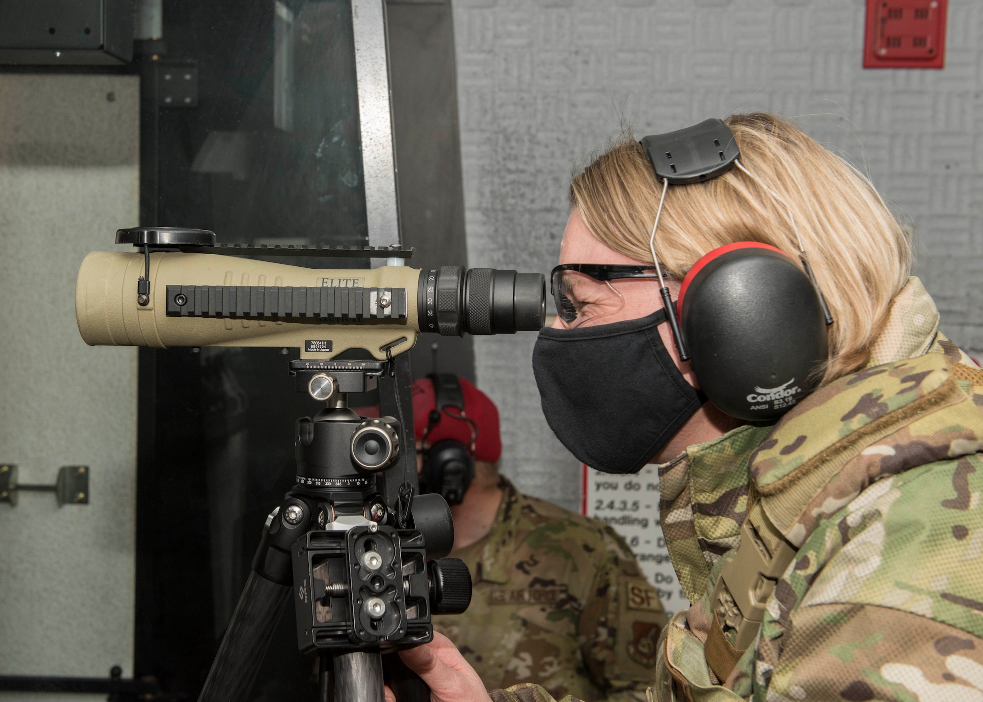 U.S. Air Force Col. Kirsten Aguilar, the Joint Base Elmendorf-Richardson and 673d Air Base Wing commander, looks through a scope during an immersion with the 673d Security Forces Squadron at JBER, Alaska, Feb. 2, 2021. The tour familiarized base leadership with the 673d SFS and its role in maintaining the safety of the JBER community and security of the installation and its resources.
