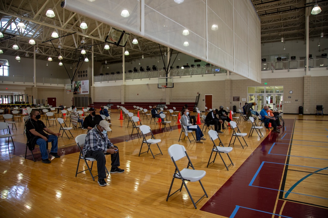 Service members and veterans wait to be checked out of the COVID-19 vaccination center after being vaccinated at the Wallace Creek Fitness Center gym on Marine Corps Base Camp Lejeune, North Carolina, Feb. 16, 2021. Beginning Feb. 16, 2021, Naval Medical Center Camp Lejeune personnel will be able to provide vaccinations for any eligible personnel with the capability of vaccinating up to 2000 people per day. (U.S. Marine Corps Photo by Lance Cpl. Isaiah Gomez)