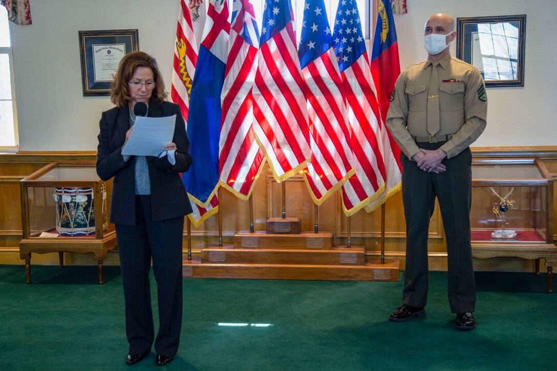 Sarah Wiltgen, left, assistant chief of staff for Marine Corps Community Services, gives her remarks during a ceremony to honor the 2020 Service Member of the Year, Staff Sgt. Justin A. Collins, a motor vehicle operator with Combat Logistics Battalion 8, Combat Logistics Regiment 2, 2nd Marine Logistics Group, at building 1 on Marine Corps Base Camp Lejeune, North Carolina, Feb. 8, 2021. The Jacksonville-Onslow Chamber of Commerce, Military Affairs Committee, recognized Collins for his outstanding performance and dedication. (U.S. Marine Corps photo by Cpl. Karina Lopezmata)