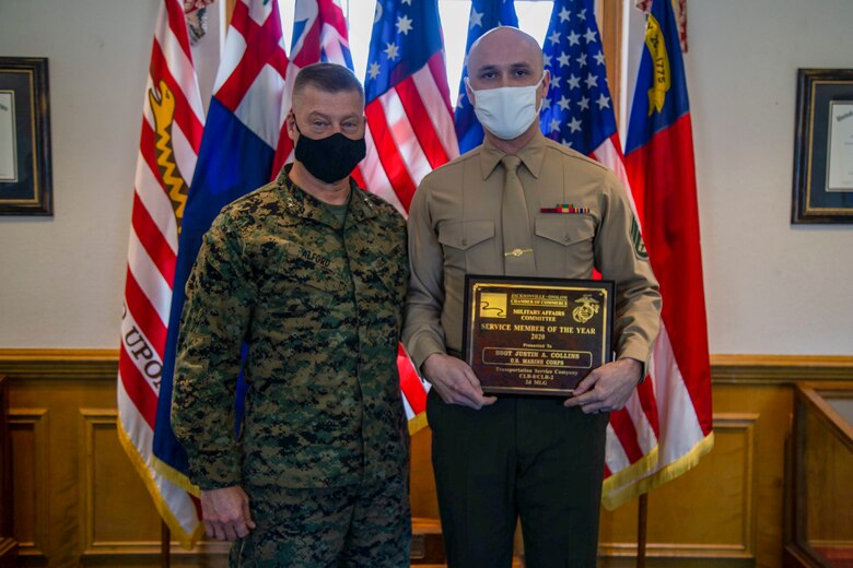U.S. Marine Corps Maj. Gen. Julian D. Alford, left, commanding general for Marine Corps Installations East-Marine Corps Base Camp Lejeune, poses for a photo with Staff Sgt. Justin A. Collins, right, a motor vehicle operator with Combat Logistics Battalion 8, Combat Logistics Regiment 2, 2nd Marine Logistics Group, following a recognition ceremony in his honor as the 2020 Service Member of the Year at building 1 on MCB Camp Lejeune, North Carolina, Feb. 8, 2021. The Jacksonville-Onslow Chamber of Commerce, Military Affairs Committee, recognized Collins for his outstanding performance and dedication. (U.S. Marine Corps photo by Cpl. Karina Lopezmata)
