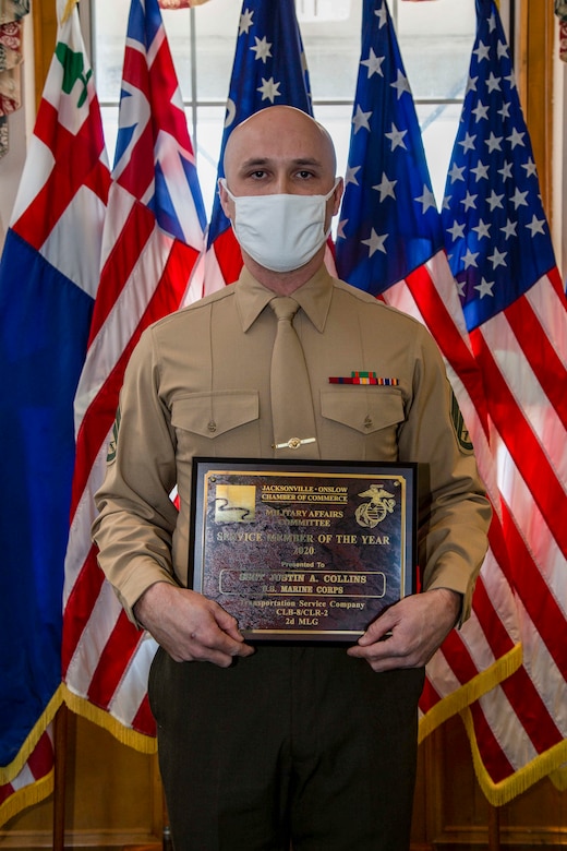 U.S. Marine Corps Staff Sgt. Justin A. Collins, a motor vehicle operator with Combat Logistics Battalion 8, Combat Logistics Regiment 2, 2nd Marine Logistics Group, poses for a photo following a recognition ceremony in his honor as the 2020 Service Member of the Year at building 1 on Marine Corps Base Camp Lejeune, North Carolina, Feb. 8, 2021. The Jacksonville-Onslow Chamber of Commerce, Military Affairs Committee, recognized Collins for his outstanding performance and dedication. (U.S. Marine Corps photo by Cpl. Karina Lopezmata)