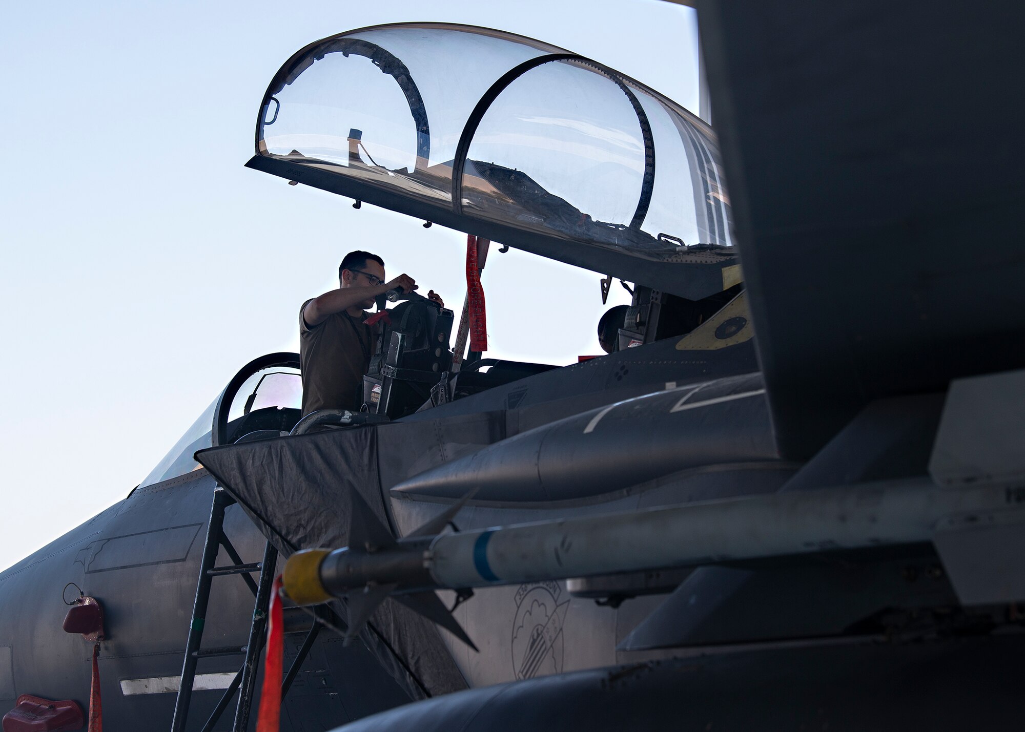 U.S. Air Force Senior Airman Mark Barnhouse, 380th Expeditionary Aircraft Maintenance Squadron (EAMXS) phase inspection journeyman, inspects the pilot seat of an F-15E Strike Eagle assigned to the 335th Expeditionary Fighter Squadron (EFS) at Al Dhafra Air Base, United Arab Emirates, Feb. 12, 2021.