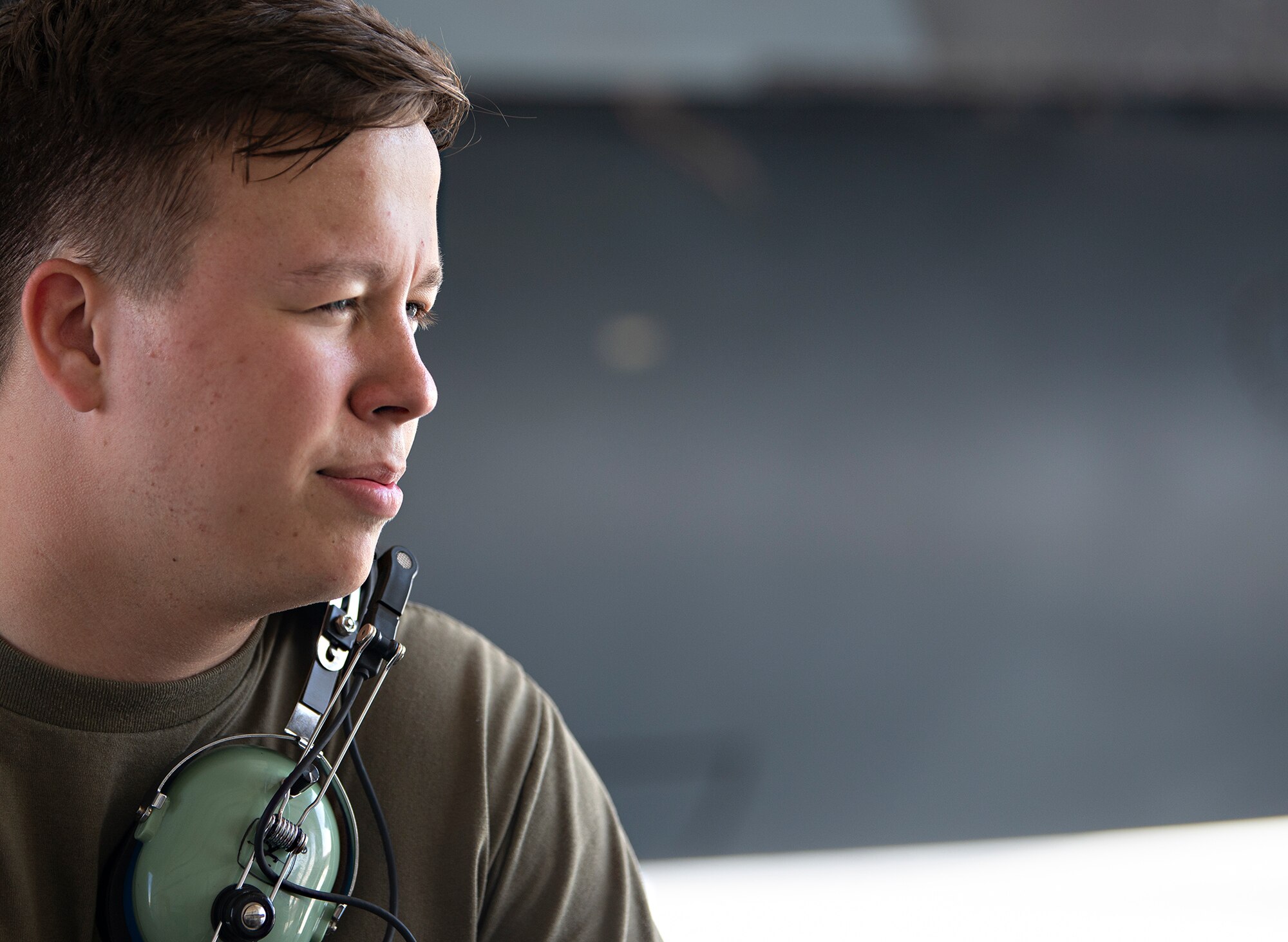 U.S. Air Force Airman 1st Class John Lanam, 380th Expeditionary Aircraft Maintenance Squadron F-15E Strike Eagle crew chief, talks with maintenance personnel at Al Dhafra Air Base, United Arab Emirates, Feb. 12, 2021.