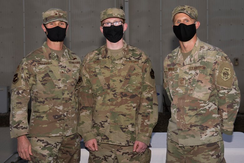 A U.S. Space Force defender assigned to the 380th Air Expeditionary Wing poses with wing leadership following a transfer ceremony at Al Dhafra Air Base, United Arab Emirates, Feb. 12, 2021.