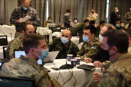 Soldiers from the United States, Uzbekistan, and Tajikistan work together to plan the multilateral exercise REGIONAL COOPERATION 21 in Helena, Montana, Feb. 3, 2021. Twelve representatives from Central Asian countries visited Montana for this initial planning conference.