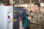 U.S. Air Force Senior Master Sgt. Robert Cliché, flight chief of the 116th Aerospace Ground Equipment Flight, Georgia Air National Guard, shows off new ground power units (GPUs) at Robins Air Force Base, Georgia, Jan. 21, 2021. Squadron Innovative Funding used to obtain the new specialized aircraft generators was the first step in Team JSTARS replacing the aging GPUs.