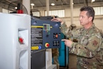 U.S. Air Force Senior Master Sgt. Robert Cliché, flight chief of the 116th Aerospace Ground Equipment Flight, Georgia Air National Guard, shows off new ground power units (GPUs) at Robins Air Force Base, Georgia, Jan. 21, 2021. Squadron Innovative Funding used to obtain the new specialized aircraft generators was the first step in Team JSTARS replacing the aging GPUs.