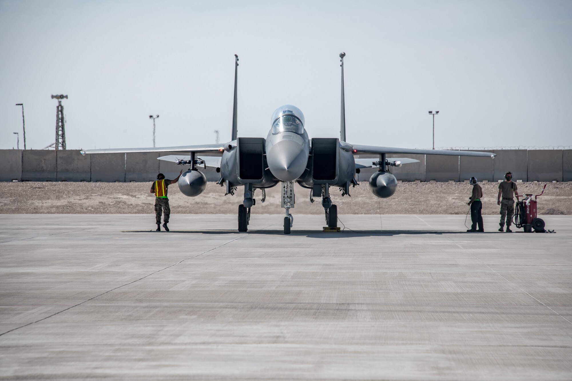 an F-15 sits on a runway