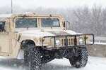 An Oklahoma Army National Guard HUMVEE moves through the snow near Stroud, Oklahoma. The Oklahoma Army National Guard in partnership with the Oklahoma Highway Patrol responded to numerous calls for help caused by severe weather conditions Feb. 14-15, 2021, as part of eight Stranded Motorist Assistance Recovery Teams (SMART) made up of nearly 90 Soldiers.
