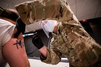 Army Pvt. Hunter Rodgers, assigned to Urban Augmentation Medical Task Force-531, based out of Fort Campbell, Ky., administers a COVID-19 vaccine to a local New Jersey citizen in support of COVID-19 vaccine operations.
