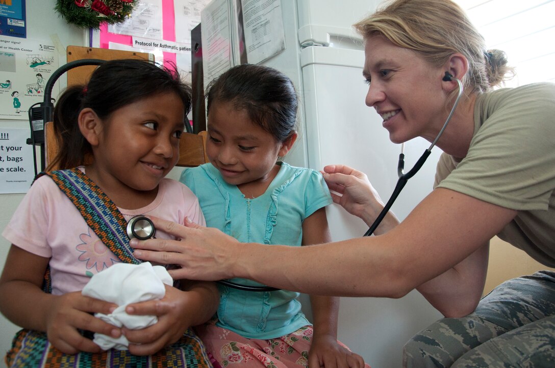 Airman with New Horizons mobile forward surgical team listens to heart and lungs of Belizean girl during medical readiness training exercise, May 1, 2014, in Santa Teresa, Belize (U.S. Air Force/Kali L. Gradishar)