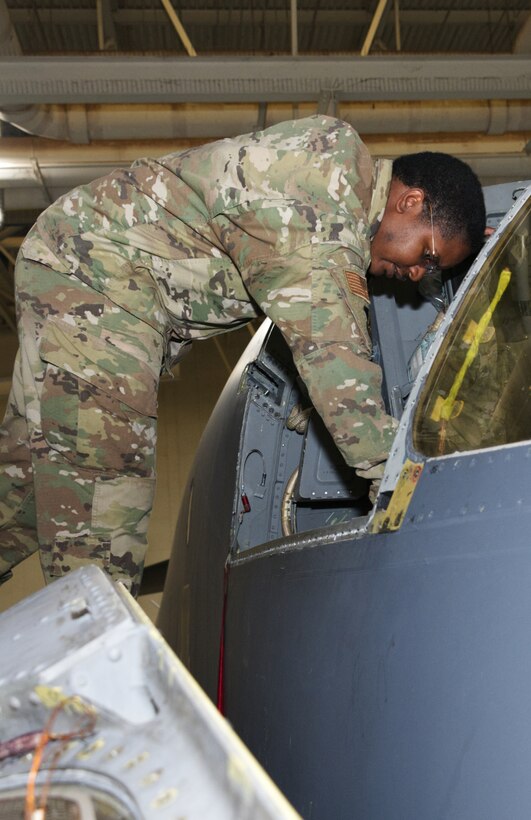 An Airman works on the cockpit seat of a B-1 Lancer.