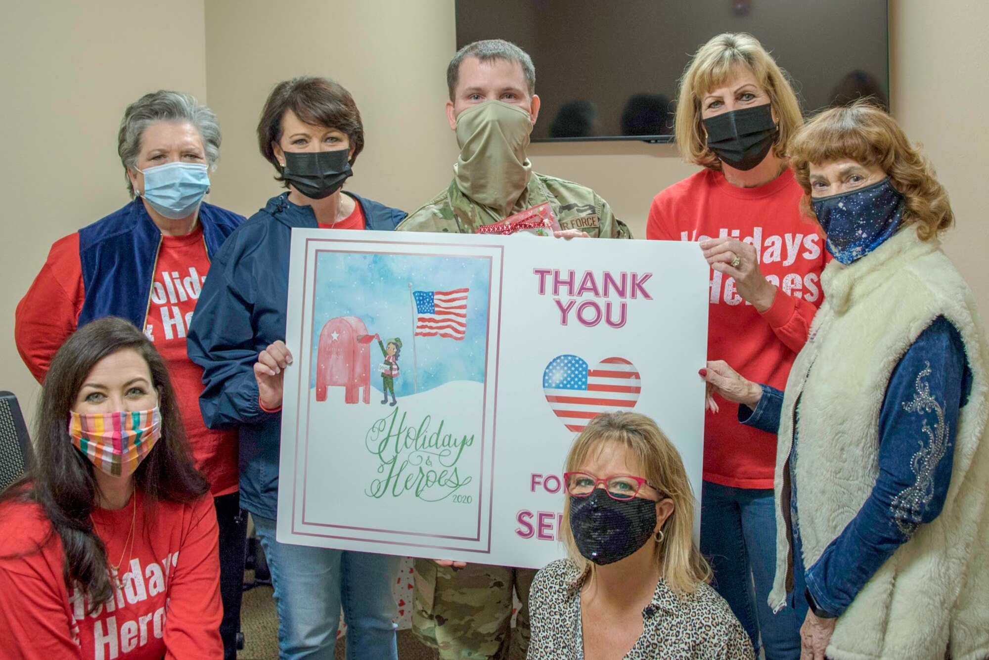 Senior Airman William Downs, 301st Fighter Wing public affairs specialist, receives a surprise thank you from volunteers with the non-profit organization, Holidays and Heroes at U.S. Naval Air Station Joint Reserve Base Fort Worth, Texas on February 5, 2021. The organization, traditionally known for their annual Christmas event, sponsored over 100 military families last year. They contacted each military member from last year's event to send some additional Valentine’s Day themed love, gifts and support for their military members. (Courtesy photo)