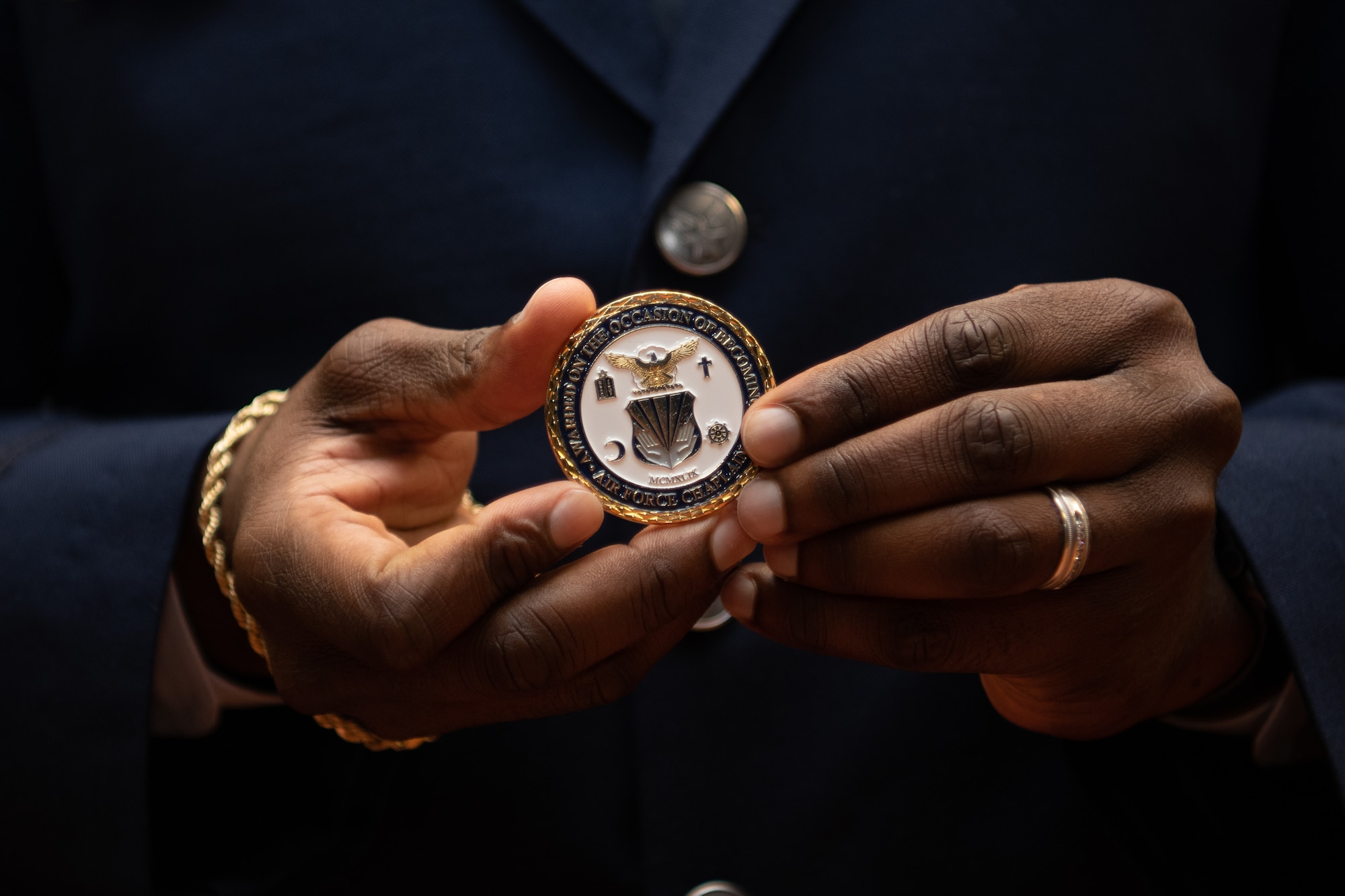 1st Lt. Fred Gallop III, a graduate of Basic Chaplain Course Class 21A, holds his Air Force chaplain coin up for a photo Feb. 5, 2021, at the Ira C. Eaker Center for Leadership Development on Maxwell Air Force Base, Ala. Each graduate was presented with a numbered coin during the graduation ceremony.
