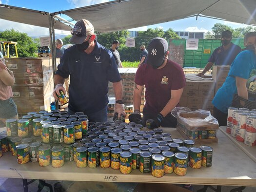 A U.S. Air Force Airman from Joint Base Pearl Harbor-Hickam, Hawaii, sorts canned food at the Hawaiian Foodbank, in Honolulu, Hawaii, Jan. 16, 2021. The Hawaiian Foodbank distributes 2,000 food boxes monthly to seniors on two of the Hawaiian islands.  (U.S. Air Force photo by Tech. Sgt. Anthony Nelson Jr.)