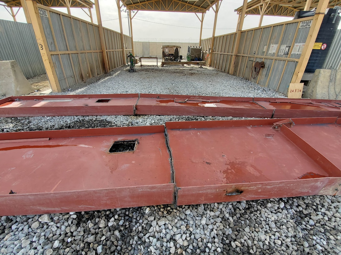 Huge pieces of building materials are reduced to more manageable sizes at a cutting bay at the DLA Disposition Services site at Bagram, Afghanistan.