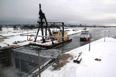 A crane ship lifts bars.