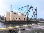 A crane barge floats.