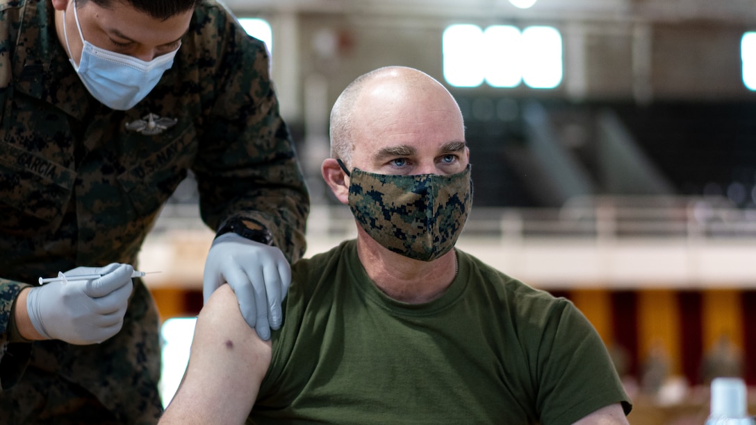 A U.S. Marine receives the the Pfizer-BioNTech COVID-19 vaccine at Goettge Memoria Field House on Camp Lejeune, N.C., Jan. 28.