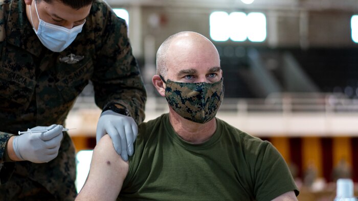 A U.S. Marine receives the the Pfizer-BioNTech COVID-19 vaccine at Goettge Memoria Field House on Camp Lejeune, N.C., Jan. 28.