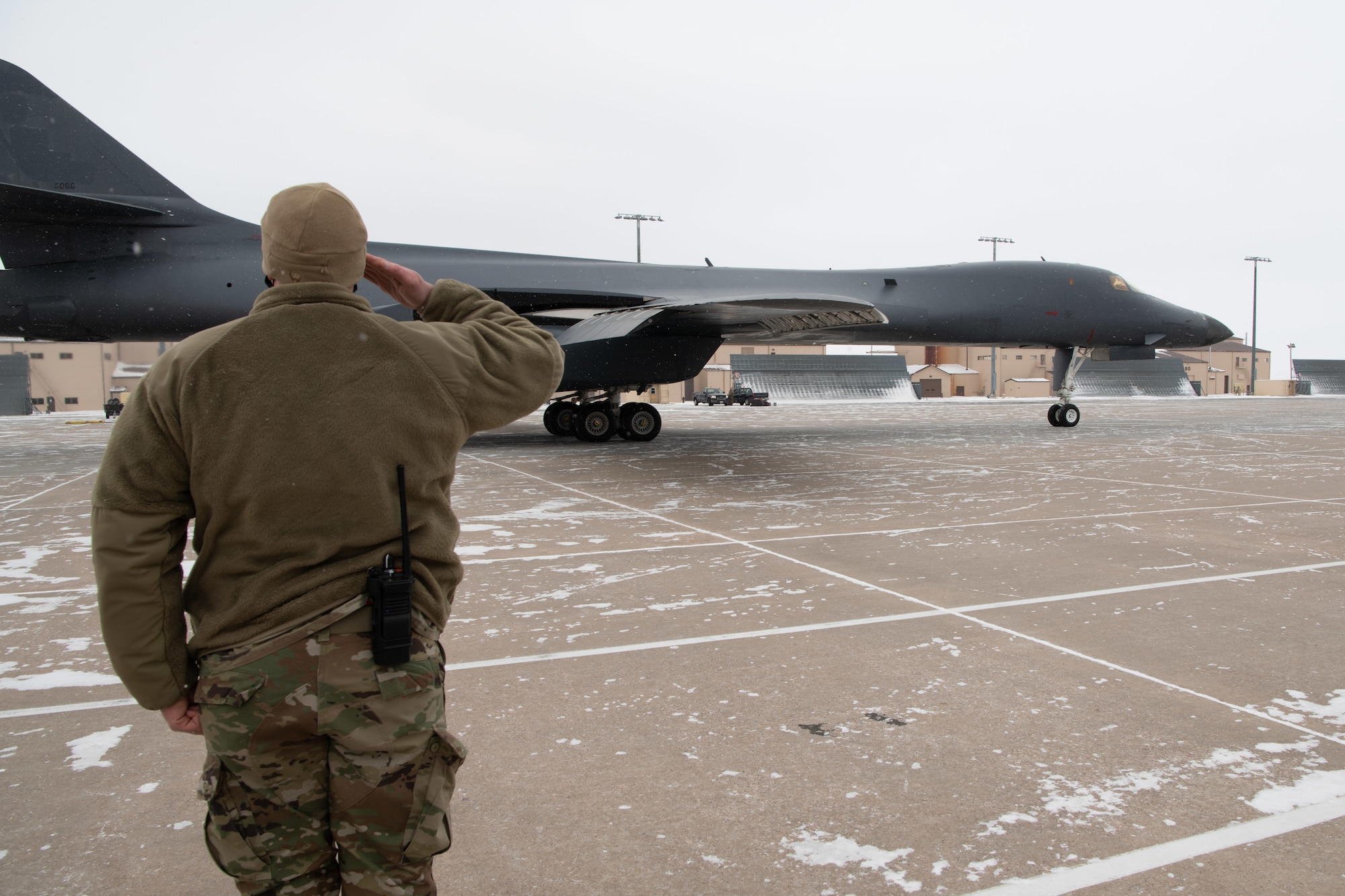Master Sgt. David Jackson, the 28th Aircraft Maintenance Squadron production superintendent, salutes a B-1B Lancer that is being divested prior to its final launch from Ellsworth Air Force Base, S.D., Feb. 17, 2021. The divestiture of the B-1 is necessary in order for the Air Force to create an even more lethal, agile and sustainable force with a greater competitive edge in today’s fight. (U.S.  Air Force photo by Airman Jonah Fronk)