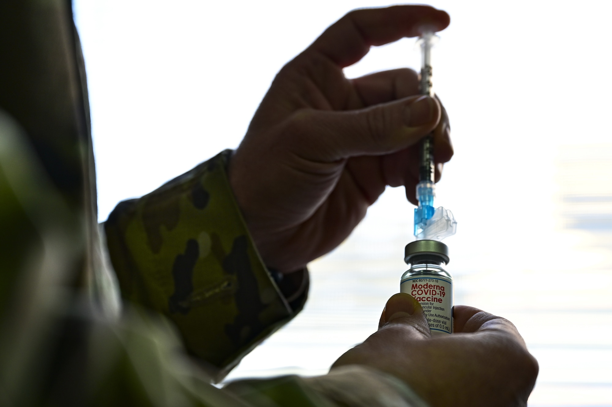 Tech. Sgt. Joseph Anthony, 911th Aeromedical Staging Squadron aeromedical technician, prepares to fill a syringe with the COVID-19 vaccine at the Pittsburgh International Airport Air Reserve Station, Pennsylvania, Feb. 4, 2021.