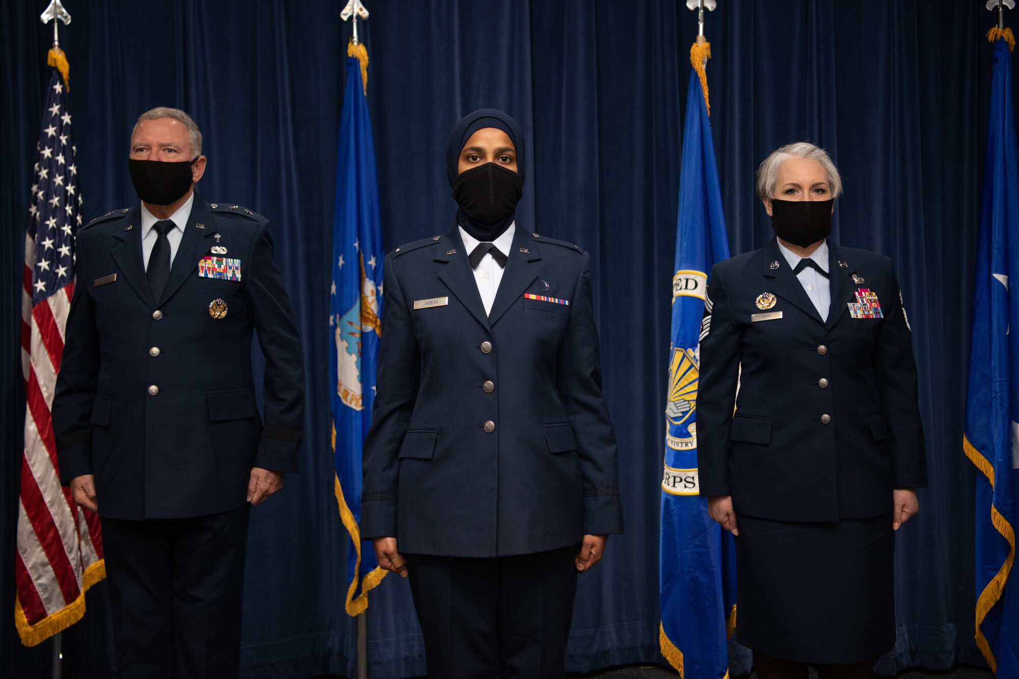 Maj. Gen. Steven Schaik, Air Force chief of chaplains, 1st Lt. Saleha Jabeen, a graduate of Basic Chaplain Course Class 21A, and Chief Master Sgt. Natalie Gray, Air Force Chaplain Corps senior enlisted advisor and religious affairs career field manager, pose for a photo during the graduation ceremony Feb. 5, 2021, at the Ira C. Eaker Center for Leadership Development on Maxwell Air Force Base, Ala. Schaik and Gray congratulated each graduate of the Basic Chaplain Course onstage as they received their chaplain coin.