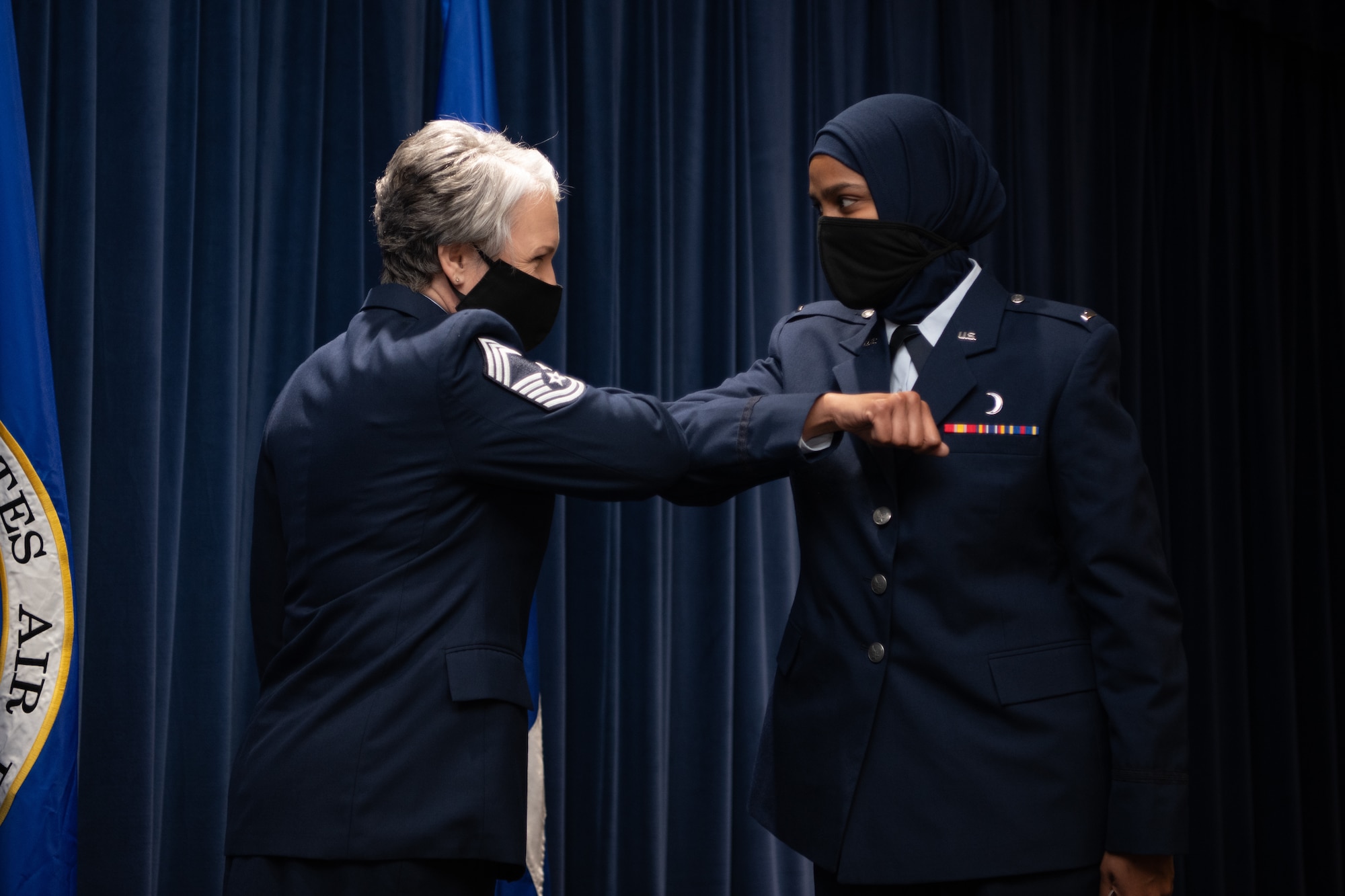 Chief Master Sgt. Natalie Gray, Air Force Chaplain Corps senior enlisted advisor and religious affairs career field manager, congratulates Chaplain 1st Lt. Saleha Jabeen, a graduate of Basic Chaplain Course Class 21A, with an elbow bump Feb. 5, 2021, at the Ira C. Eaker Center for Leadership Development on Maxwell Air Force Base, Ala. Gray attended the graduation with Maj. Gen. Steven Schaik, Air Force chief of chaplains, to celebrate the graduates’ accomplishment in a modified ceremony to adhere to guidance from the Centers for Disease Control and Prevention and the Department of Defense.