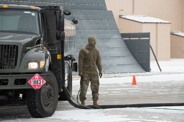 Airman 1st Class Darrian Clough, a 28th Logistics Readiness Squadron fuels specialist, fuels a B-1B Lancer being divested prior to its final takeoff from Ellsworth Air Force Base, S.D., Feb. 17, 2021. The divestiture of the B-1 is necessary in order for the Air Force to create an even more lethal, agile and sustainable force with a greater competitive edge in today’s fight. (U.S.  Air Force photo by Airman Jonah Fronk)