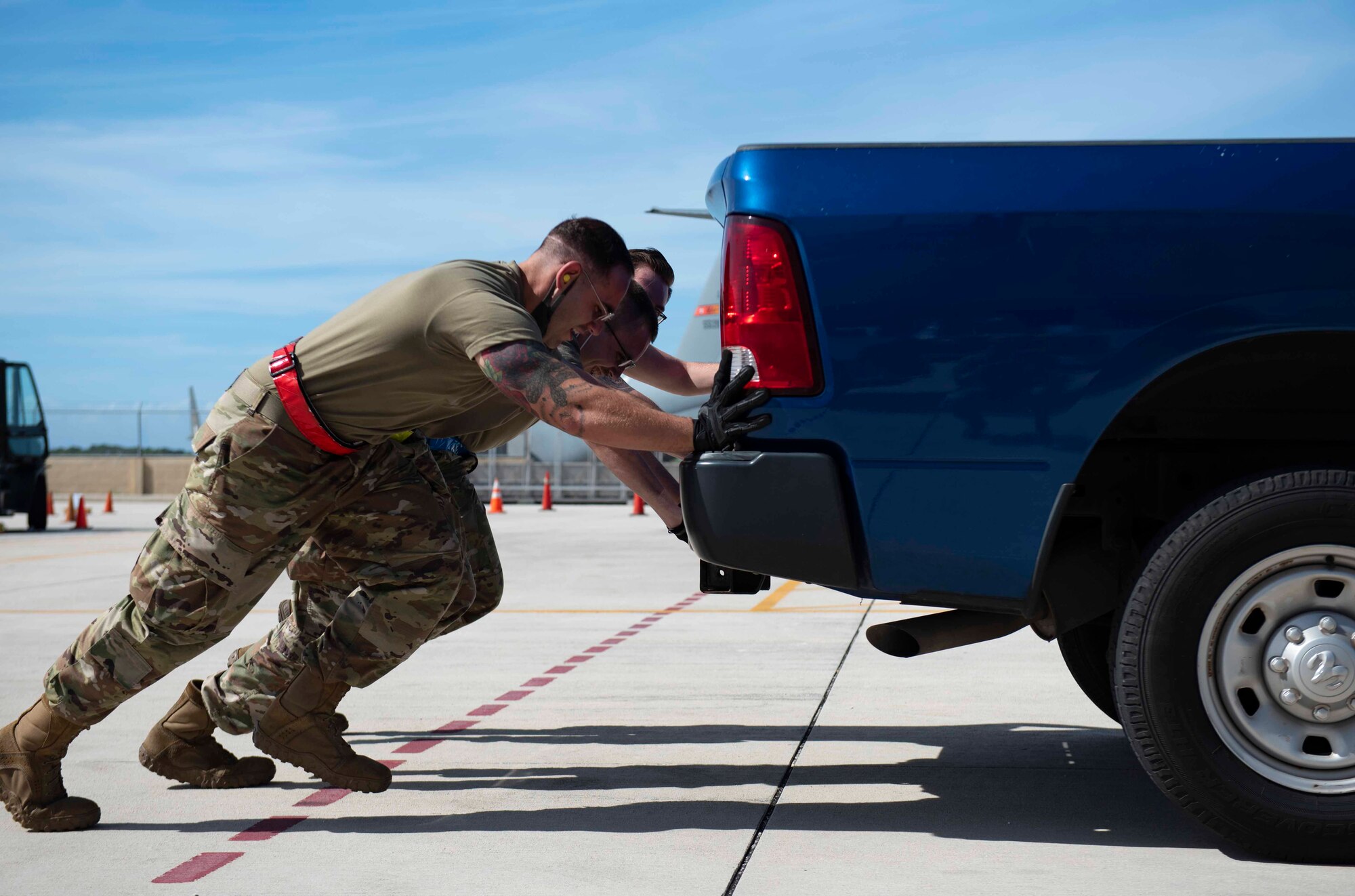 Airmen from the Air Mobility Operations Wing push a truck for part of the physical relay during the Port Dawg Rodeo at Andersen Air Force Base, Guam, Feb. 11, 2021.