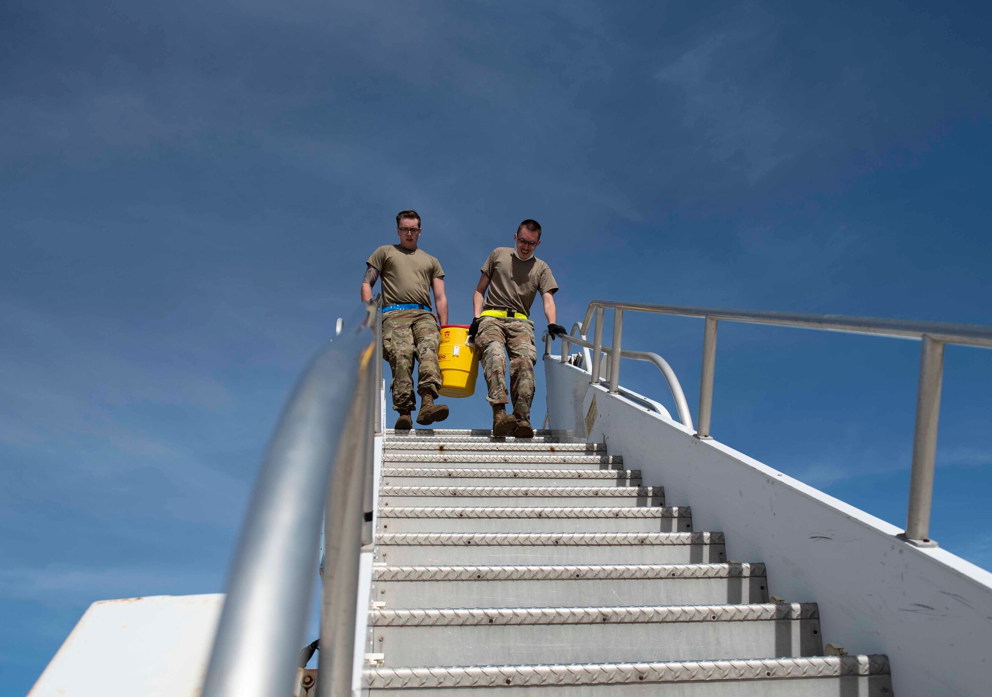 Airmen from the Air Mobility Operations Wing carry a water jug for part of the physical relay during the Port Dawg Rodeo at Andersen Air Force Base, Guam, Feb. 11, 2021.