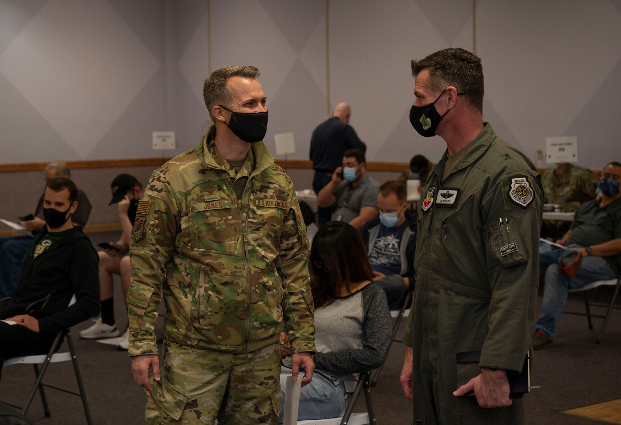 two Airmen face each other in waiting room
