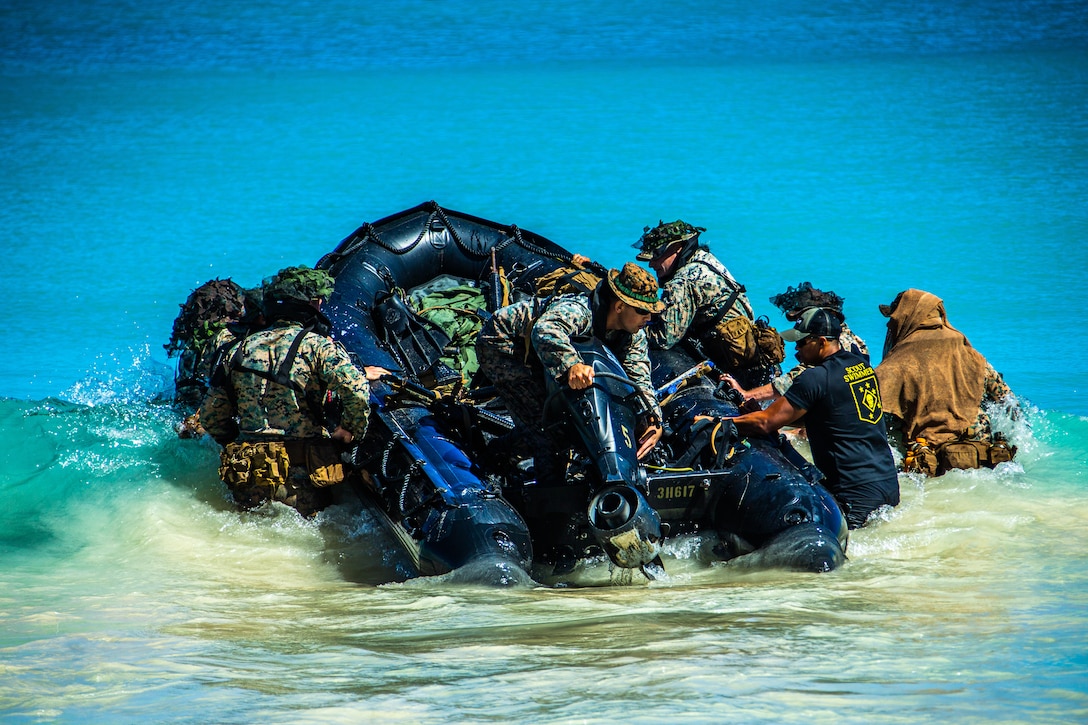 U.S. Marines embark a combat rubber raiding craft during reconnaissance scout swimmer training during Exercise Bougainville I at Marine Corps Training Area Bellows, Hawaii, Feb. 8.