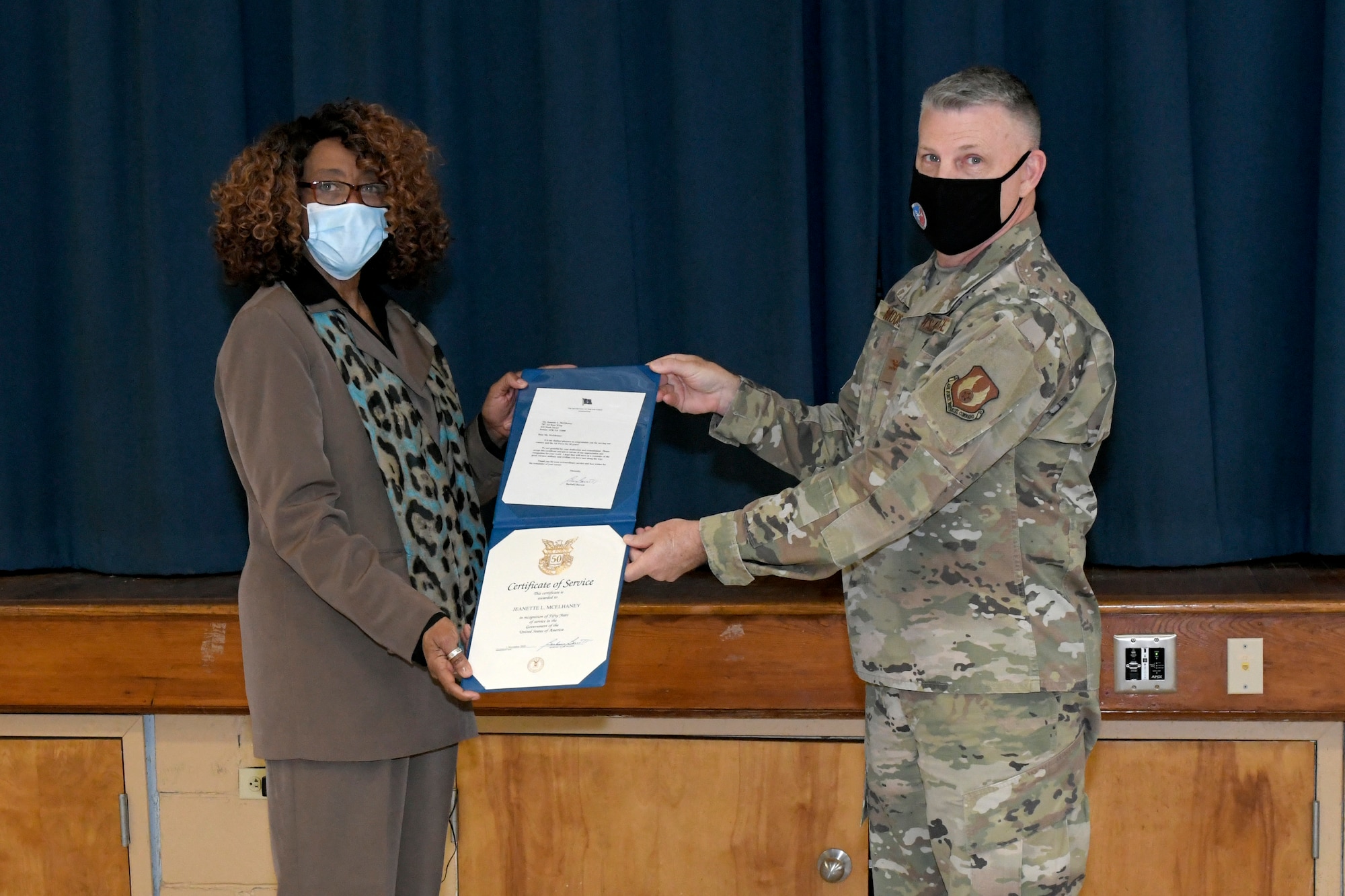 Photo shows woman getting certificate from man.