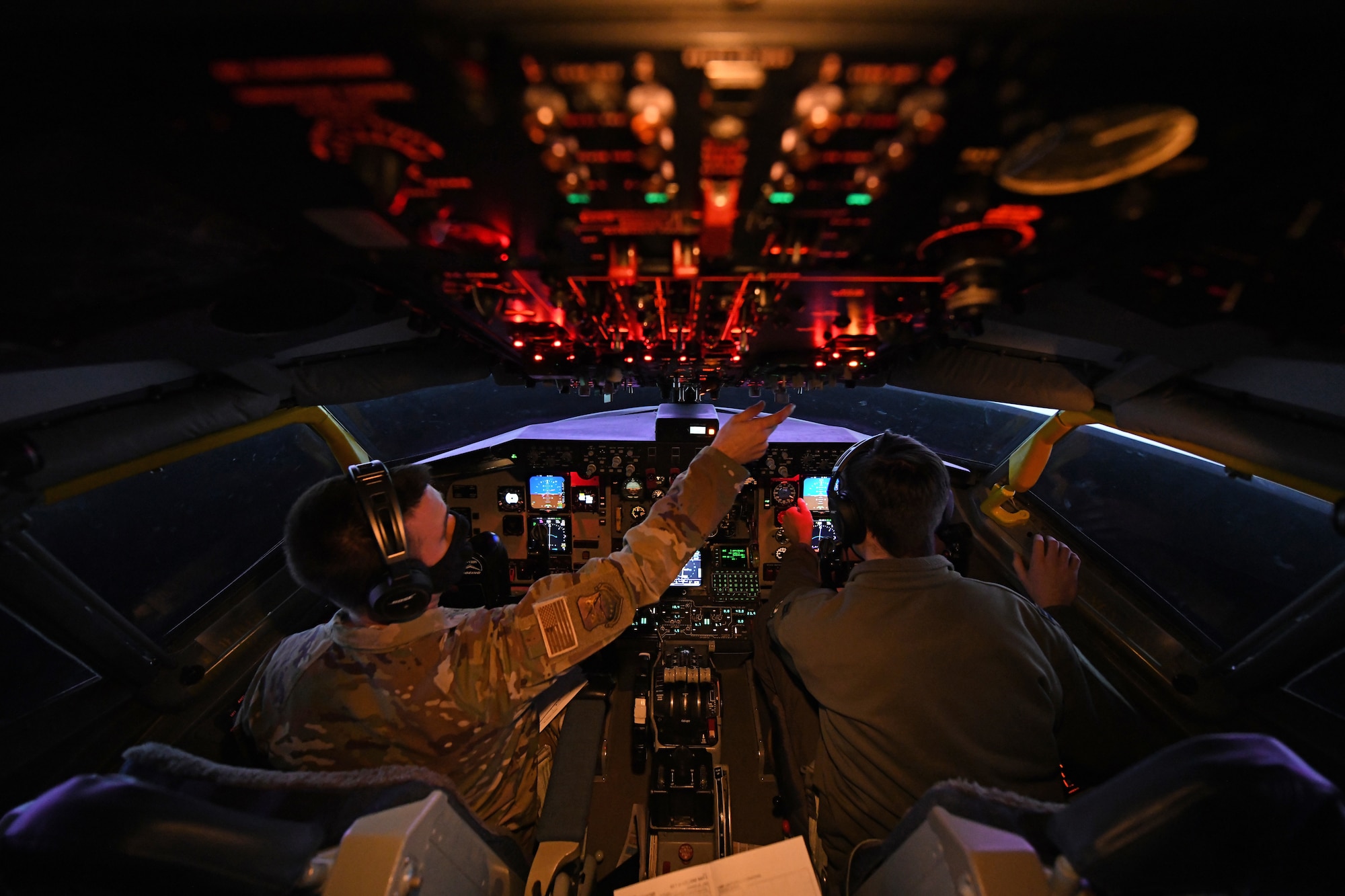 U.S. Air Force Capt. James Huff, 351st Air Refueling Squadron group mobility chief of operations, and Capt. Wilson Spreier, 100th Operations Support Squadron mission planning officer, prepare the KC-135 Stratotanker aircraft flight simulator prior to starting the Tanker Heist competition at Royal Air Force Mildenhall, England, Feb. 11, 2021. More than 60 aircrew members participated in the event, breaking into 20 teams of two pilots and one boom operator. (U.S. Air Force photo by Staff Sgt. Mackenzie Mendez)